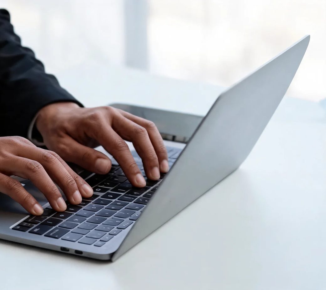 A person typing on a laptop